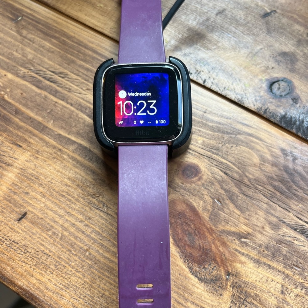 Fitbit Versa with 5 bands and charger.